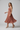 Isabelle Pleated Midi Dress — Copper Blush, model alt pose